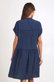 Model Madelinec wearing size 10 of the Sandy Dress – Blue in colour Blue, from the back