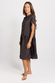 Model Genericm wearing size sample of the Sandy Dress – Brown in colour Brown, from the front