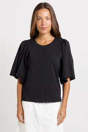 Model Genericm wearing size sample of the Bianca Broderie T-Shirt – Black in colour Black, in a cropped view