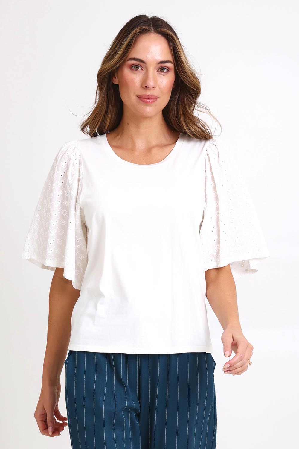 Model Madelinec wearing size 10 of the Bianca Broderie T-Shirt – White in colour White, in a cropped view