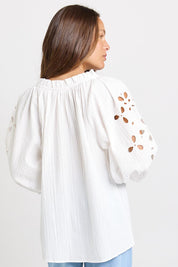 Model Genericm wearing size sample of the Daisy Broderie Blouse – White in colour White, from an angle
