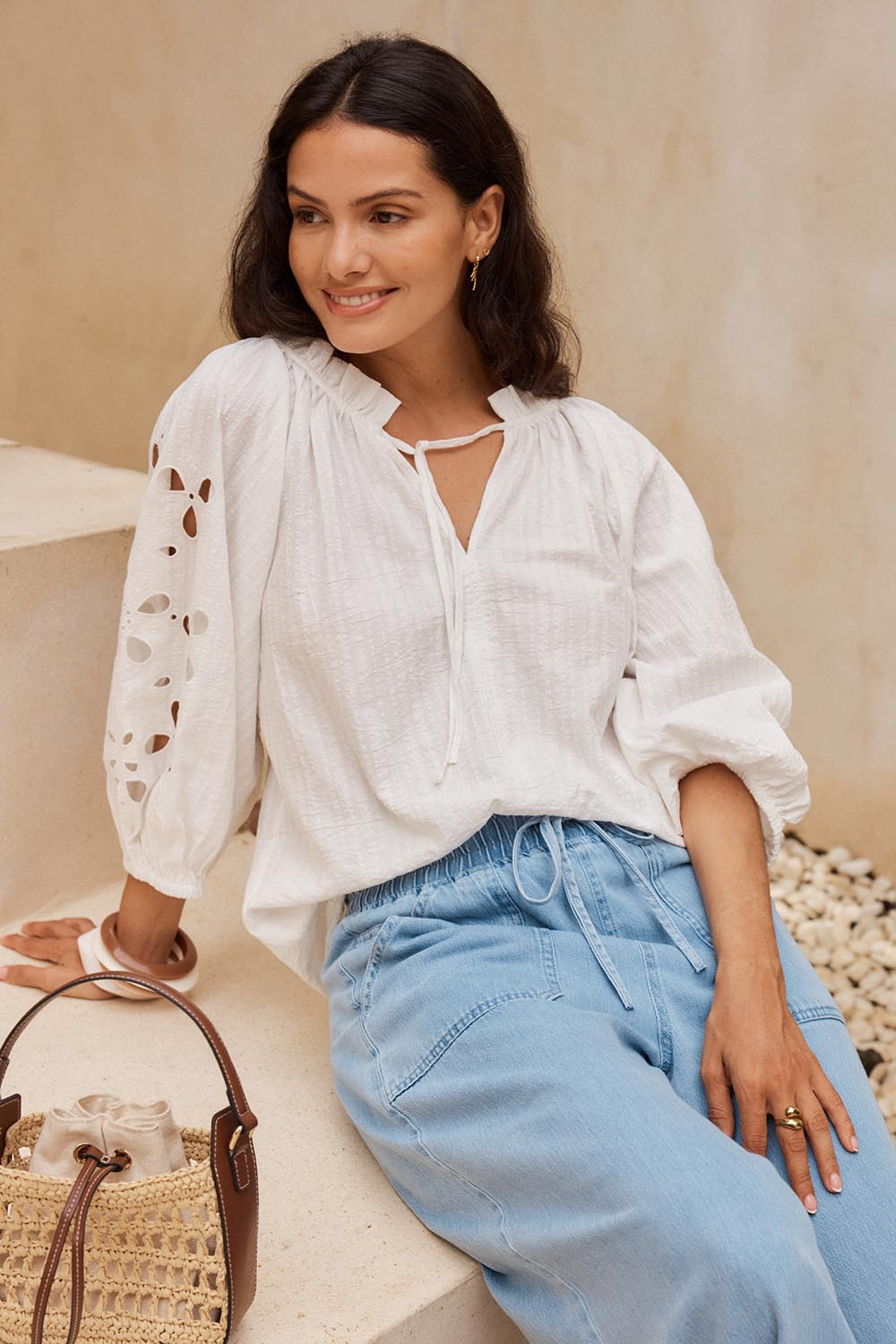 Model Genericm wearing size sample of the Daisy Broderie Blouse – White in colour White, in a cropped view