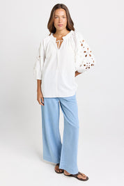 Model Genericm wearing size sample of the Daisy Broderie Blouse – White in colour White, from the front