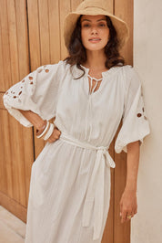 Model Genericm wearing size sample of the Nia Dress – White in colour White, from an angle
