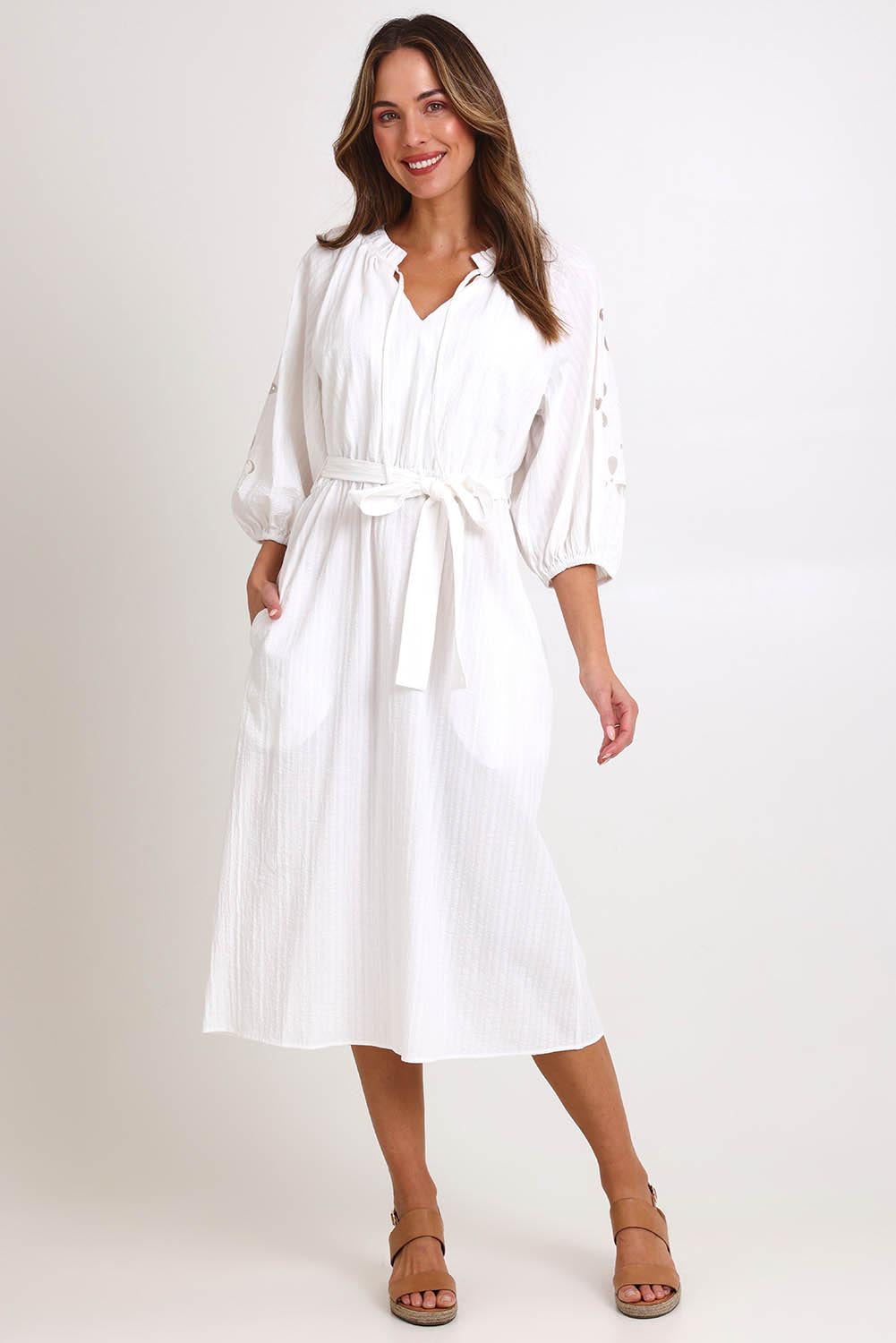 Model Madelinec wearing size 10 of the Nia Dress – White in colour White, from the front