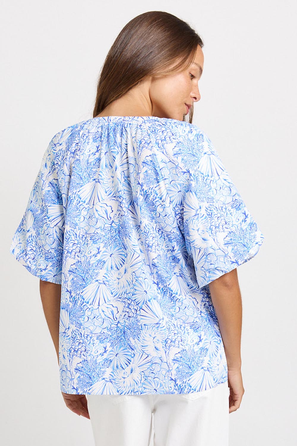 Model Genericm wearing size sample of the Bronte Blouse – Blueshell in colour Blueshell, from an angle