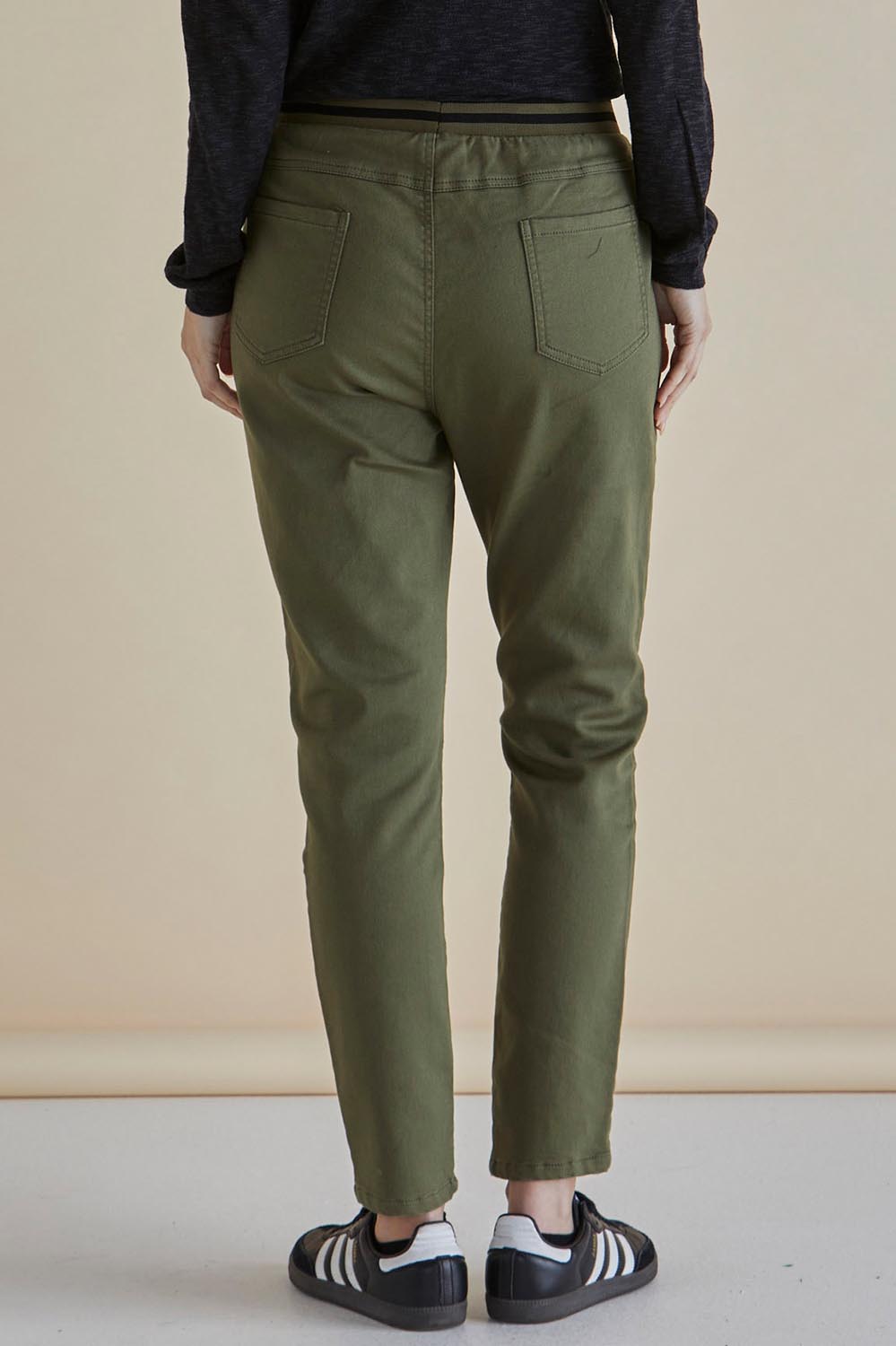 A model wearing the Dakota Denim Pant in colour Khaki (Green), from the back