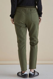 A model wearing the Dakota Denim Pant in colour Khaki (Green), from the back