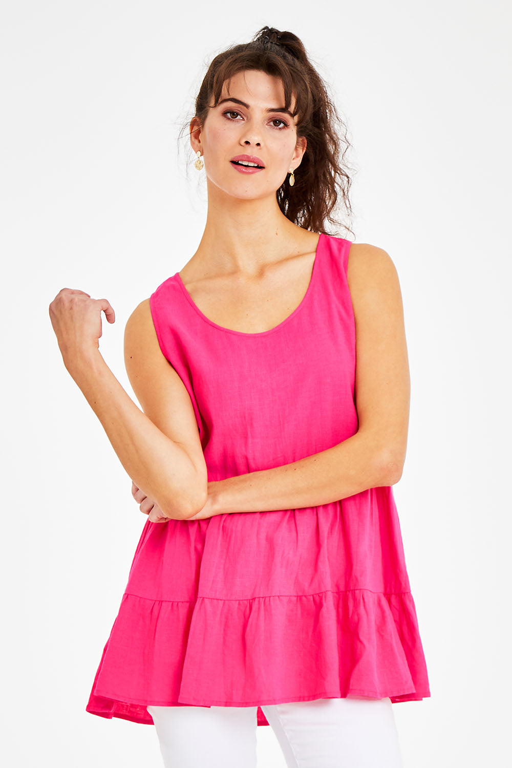 Model Courtney wearing size 10 of the Andie Top in colour Flamingo (Pink), from the front, cropped image