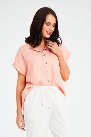 Model Andrea wearing size 10 of the Robin Shirt in colour Granita (Pink), from the front, cropped image