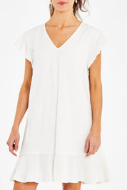 Model Courtney wearing size 10 of the Maree Dress in colour White (White), from the front, cropped image