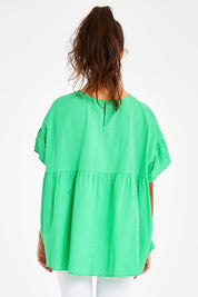 Model Courtney wearing size 10 of the Dana Top in colour Celery (Green), from the back