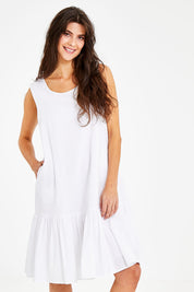 Model Courtney wearing size 10 of the Shiloh Dress in colour White (White), from the front, cropped image