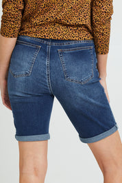 Model Grace wearing size 10 of the Bonnie Bermuda Denim in colour Indigo (Blue), from the back
