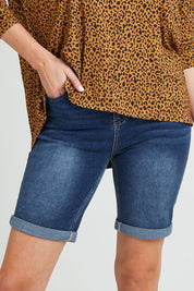 Model Grace wearing size 10 of the Bonnie Bermuda Denim in colour Indigo (Blue), from the front, cropped image