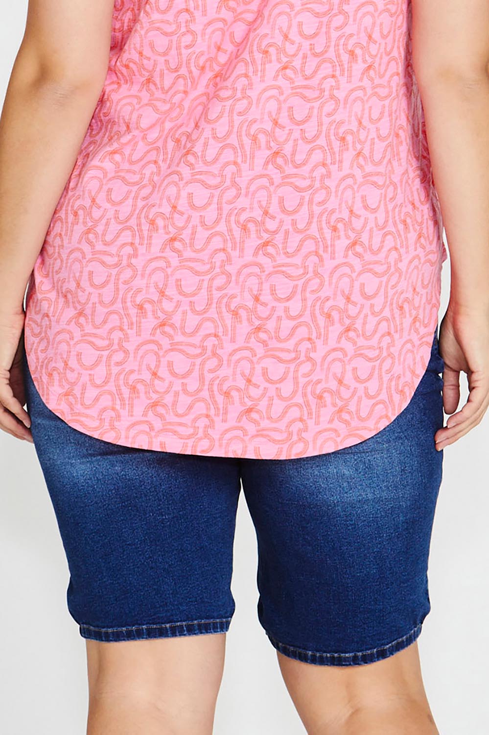 A model wearing the Bonnie Bermuda Denim Short in colour Indigo (Blue), from the back