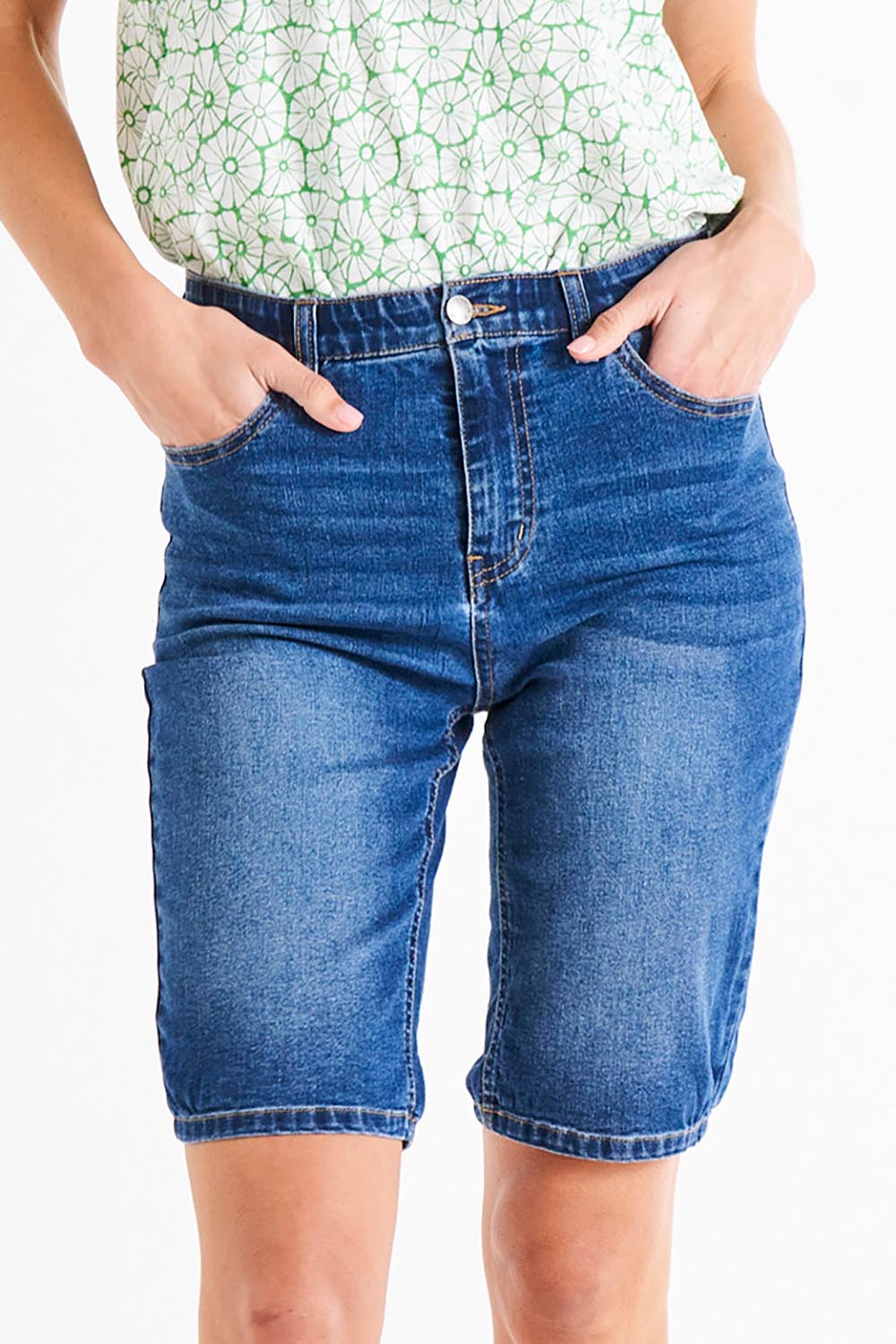 A model wearing the Bonnie Bermuda Denim Short in colour Indigo (Blue), from the front, cropped image