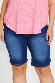 A model wearing the Bonnie Bermuda Denim Short in colour Indigo (Blue), from the front, cropped image