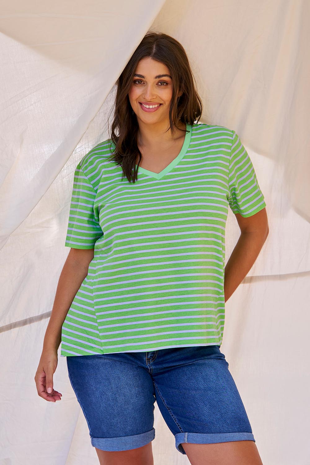 A model wearing the Bonnie Bermuda Denim Short in colour Indigo (Blue), from the front, showing the whole outfit