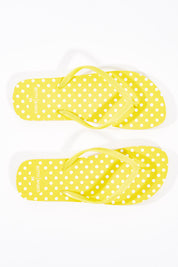 A model wearing size 37 of the Nomad Thongs in colour Yellow, from the front, showing the whole outfit