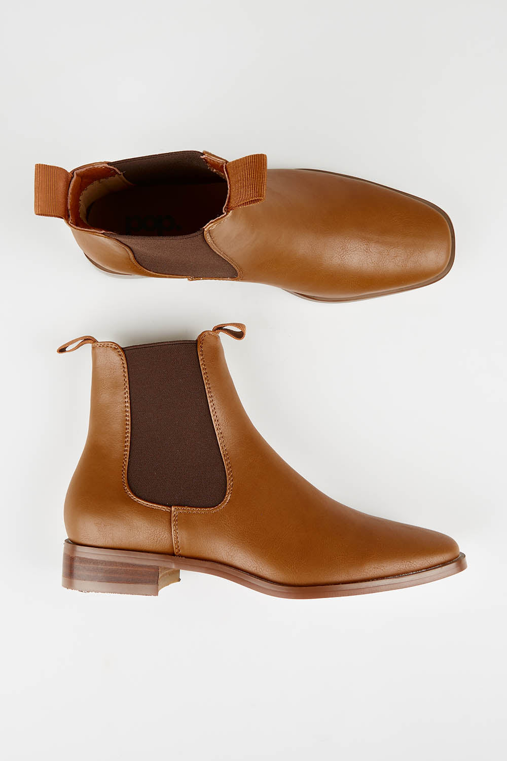 A model wearing size 37 of the Vegan Leather Pull On Flat Boot in colour Tan, from the front, showing the whole outfit