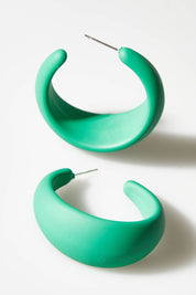 A model wearing size OneSize of the Coloured Hoop Earrings in colour Green (Green), from the front, showing the whole outfit