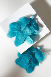 A model wearing size OneSize of the Bunch of Colour Earrings in colour Teal (Blue), from the front, showing the whole outfit
