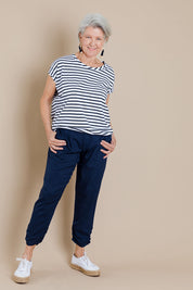 Model Elise wearing size 10 of The Best Seller Pant in colour Navy (Blue), from the front, showing the whole outfit