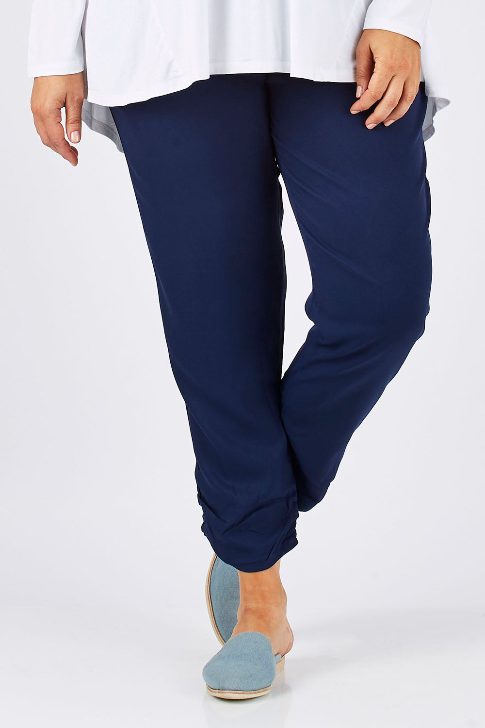Model Ljubenka wearing size 18 of The Best Seller Pant in colour Navy (Blue), from the front, cropped image