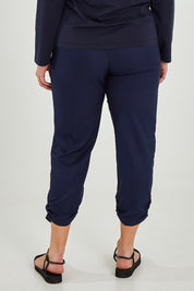 Model Maddy wearing size 16 of The Best Seller Pant in colour Navy (Blue), from the back