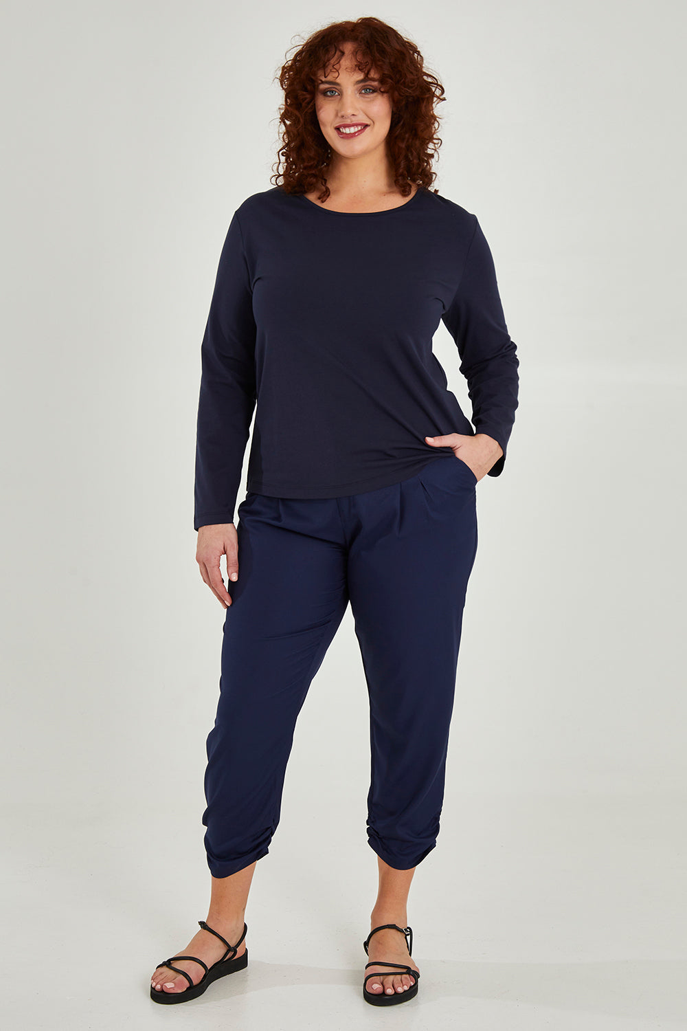 Model Maddy wearing size 16 of The Best Seller Pant in colour Navy (Blue), from the front, showing the whole outfit