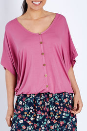 Model Pamela wearing size 10 of The Relaxed Button Bamboo Tee in colour Dustypink (Pink), from the front, cropped image