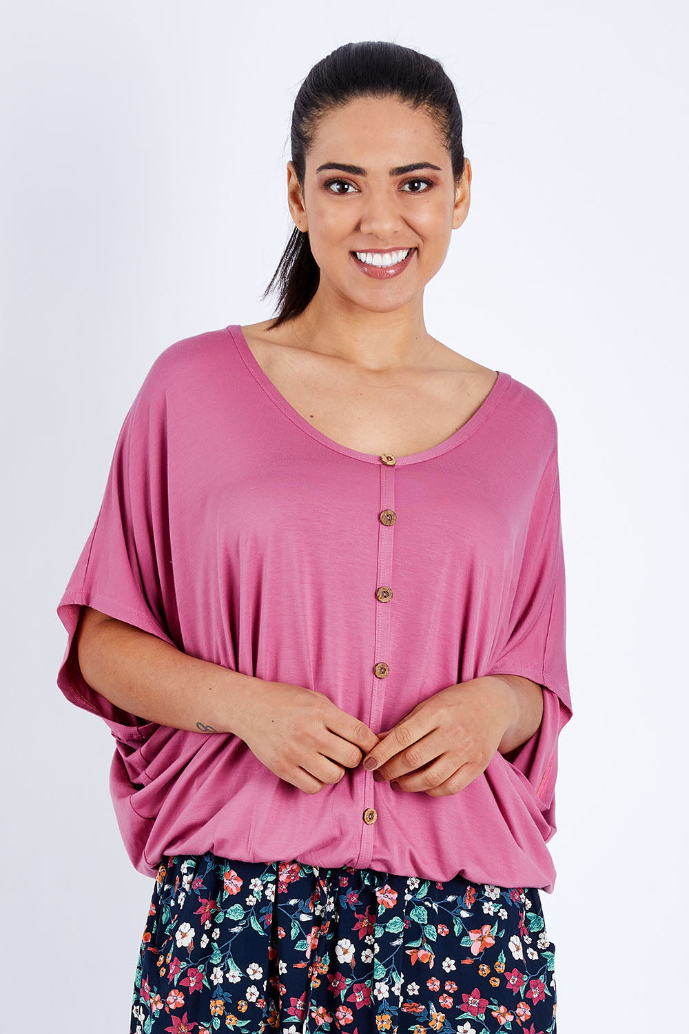 Model Pamela wearing size 10 of The Relaxed Button Bamboo Tee in colour Dustypink (Pink), from the front, cropped image