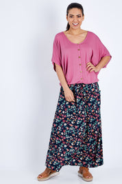 Model Pamela wearing size 10 of The Relaxed Button Bamboo Tee in colour Dustypink (Pink), from the front, showing the whole outfit