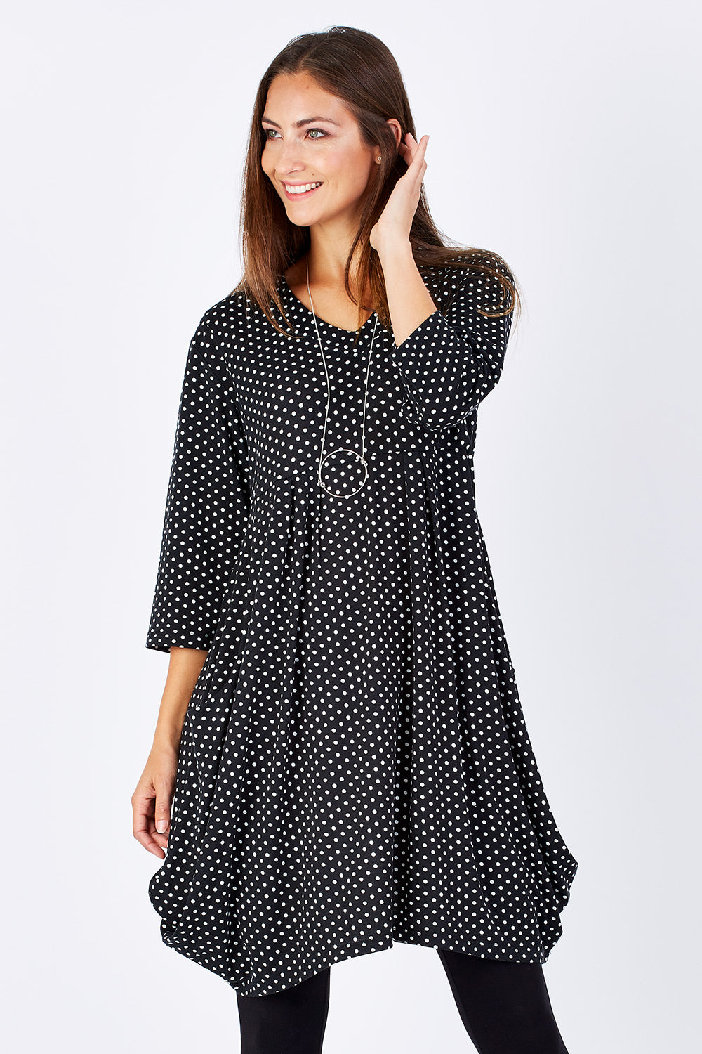 Model Anna wearing size 10 of The Spot Pocket Tunic Dress in colour Spot (Black), from the front, cropped image