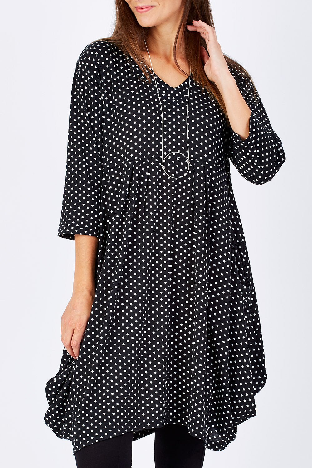 Model Anna wearing size 10 of The Spot Pocket Tunic Dress in colour Spot (Black), from the front, cropped image