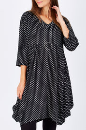Model Anna wearing size 10 of The Spot Pocket Tunic Dress in colour Spot (Black), from the front, cropped image