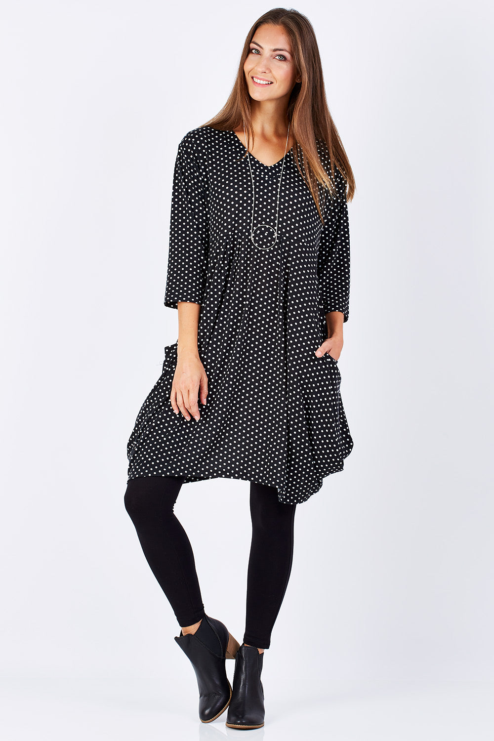 Model Anna wearing size 10 of The Spot Pocket Tunic Dress in colour Spot (Black), from the front, showing the whole outfit