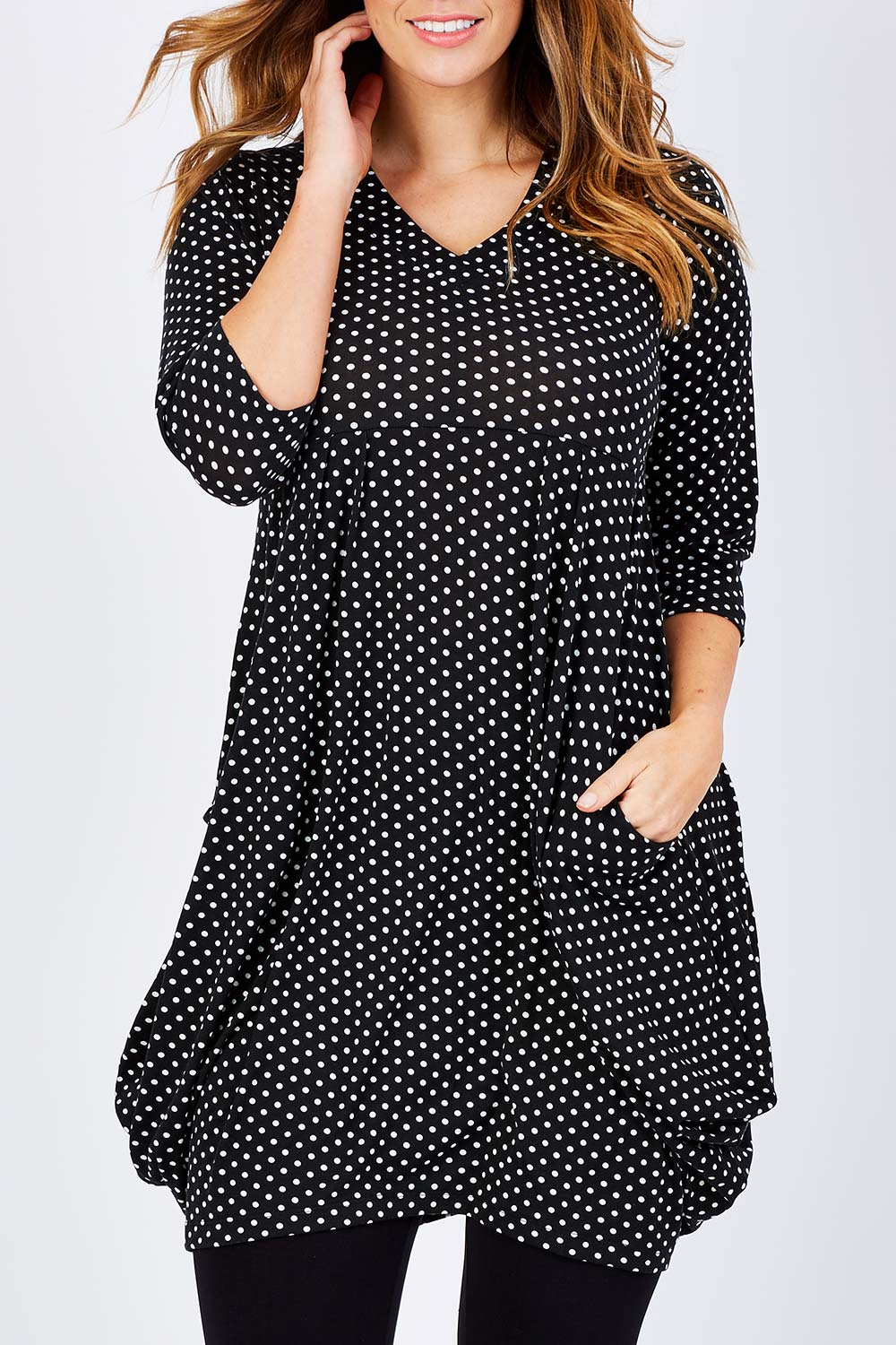 Model Laura wearing size 14 of The Spot Pocket Tunic Dress in colour Spot (Black), from the front, cropped image