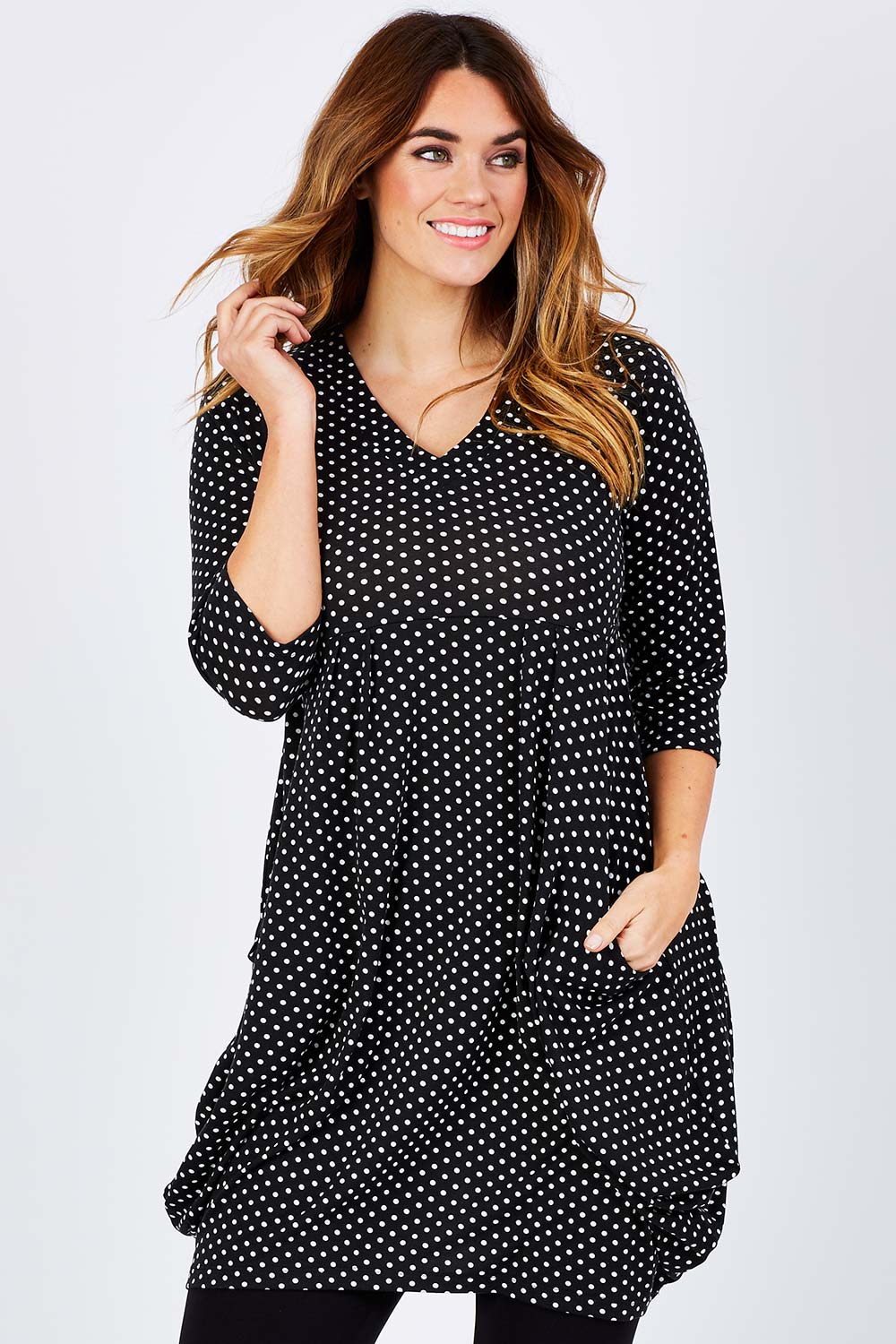 Model Laura wearing size 14 of The Spot Pocket Tunic Dress in colour Spot (Black), from the front, cropped image
