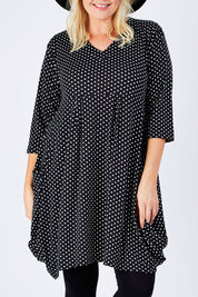 Model Natalie wearing size 16 of The Spot Pocket Tunic Dress in colour Spot (Black), from the front, cropped image