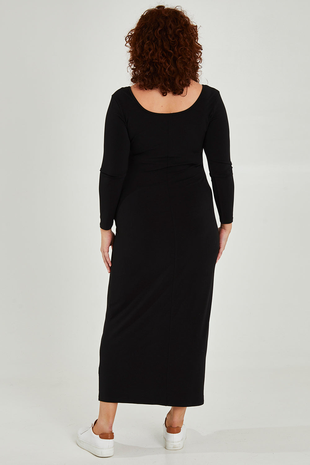 Model Maddy wearing size 16 of The Long Sleeve Comfort Maxi in colour Black (Black), from the back