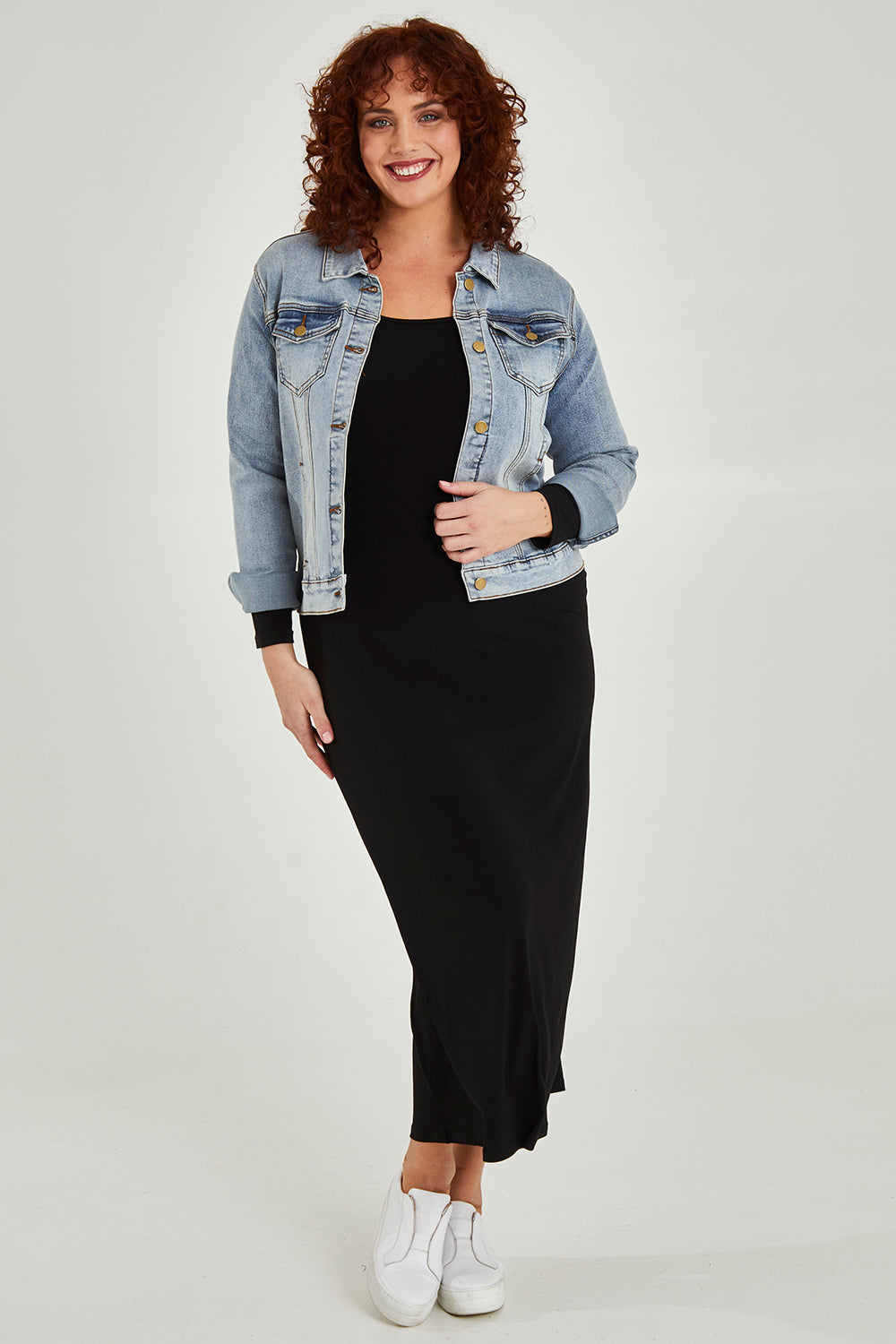 Model Maddy wearing size 16 of The Long Sleeve Comfort Maxi in colour Black (Black), from the front, showing the whole outfit