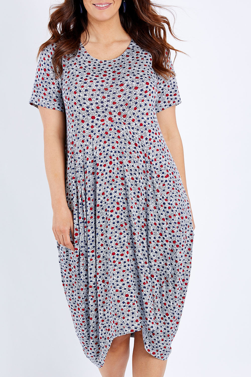 Model Laura wearing size 14 of The Short Sleeve Bounce Dress in colour Spot (White), from the front, cropped image