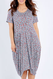 Model Laura wearing size 14 of The Short Sleeve Bounce Dress in colour Spot (White), from the front, cropped image