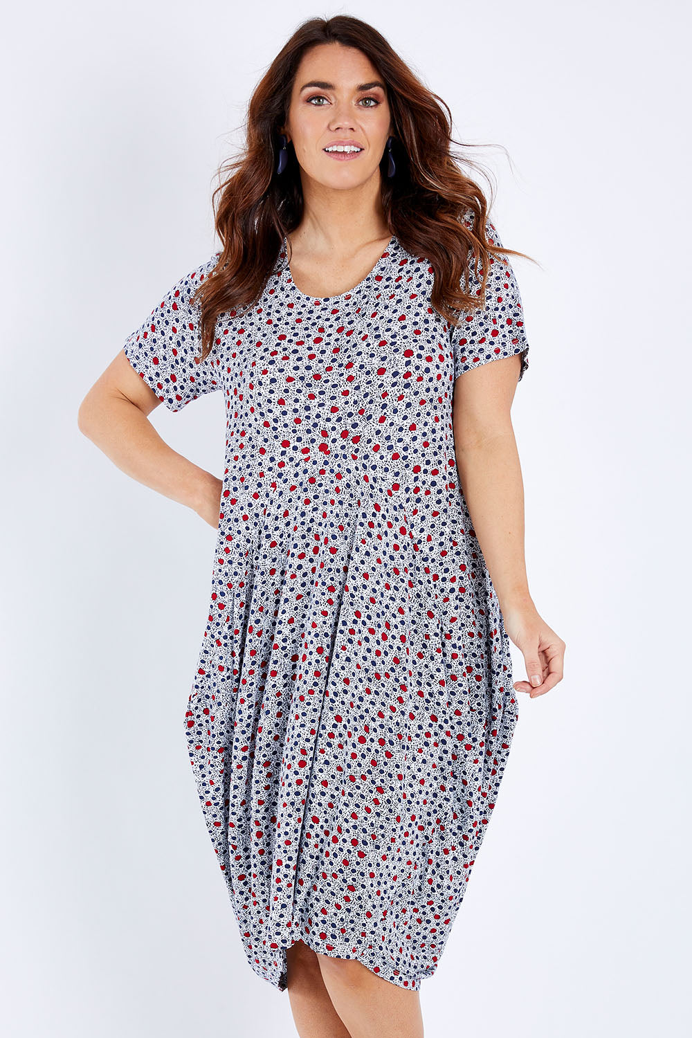 Model Laura wearing size 14 of The Short Sleeve Bounce Dress in colour Spot (White), from the front, cropped image