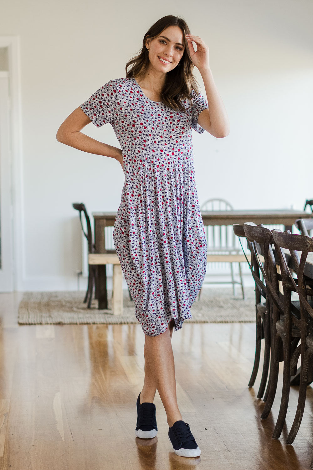 Model Madeline wearing size 10 of The Short Sleeve Bounce Dress in colour Spot (White), from the front, showing the whole outfit