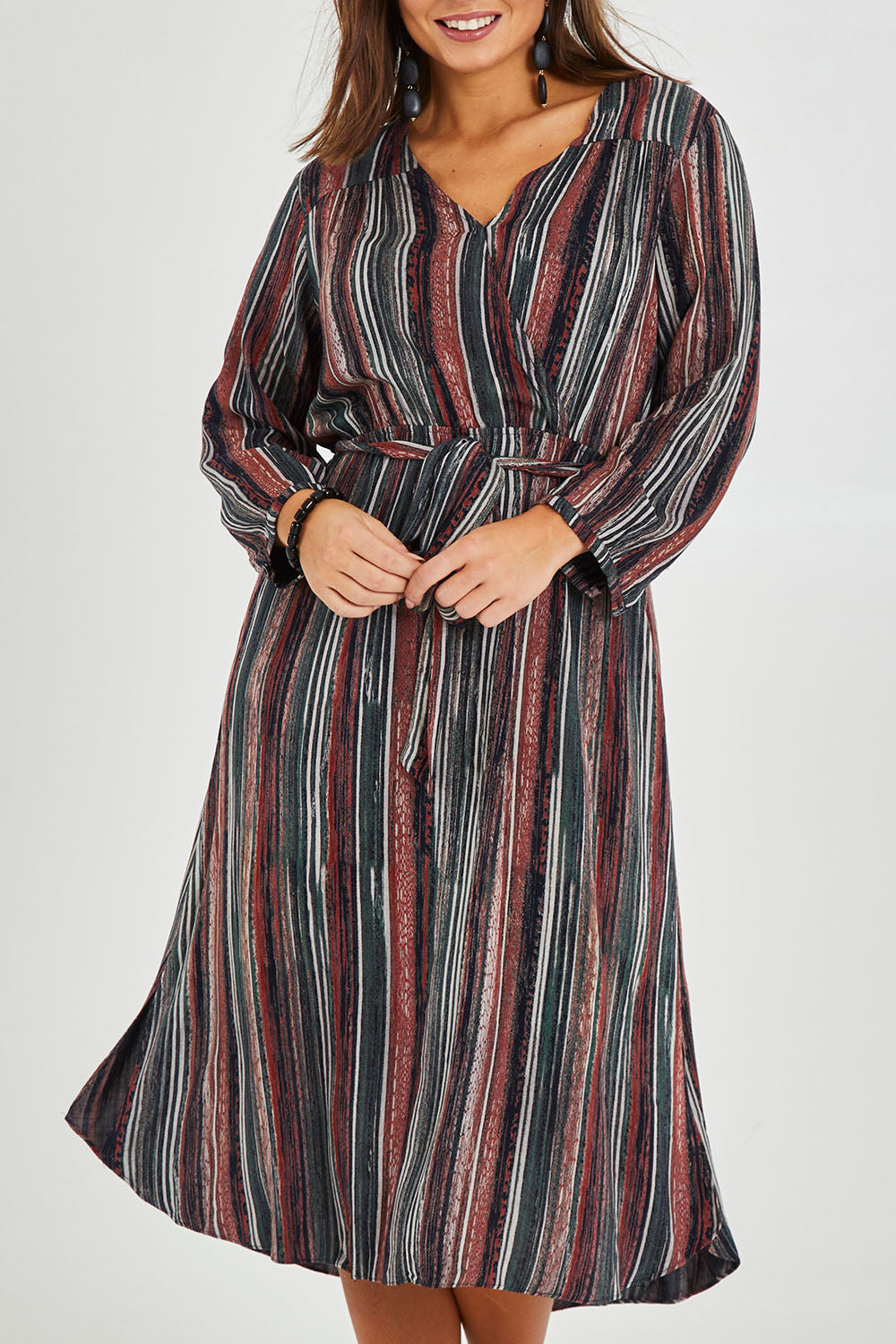 Model Monique wearing size 14 of The Wrap Front Midi Dress in colour Multistrip (Black), from the front, cropped image