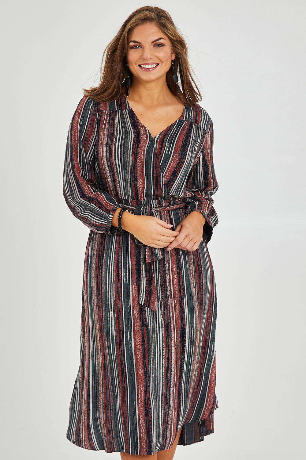 Model Monique wearing size 14 of The Wrap Front Midi Dress in colour Multistrip (Black), from the front, cropped image