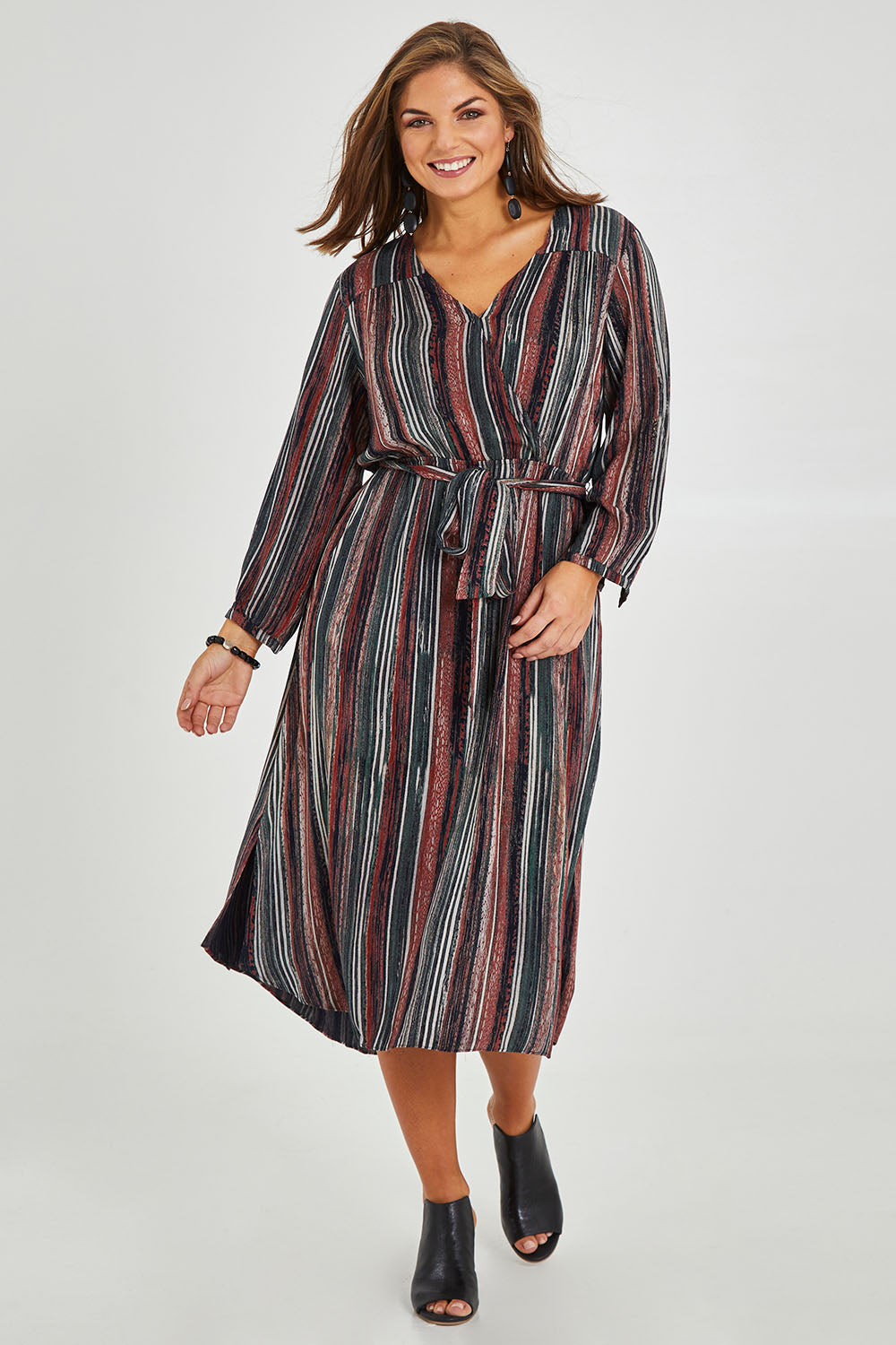 Model Monique wearing size 14 of The Wrap Front Midi Dress in colour Multistrip (Black), from the front, showing the whole outfit